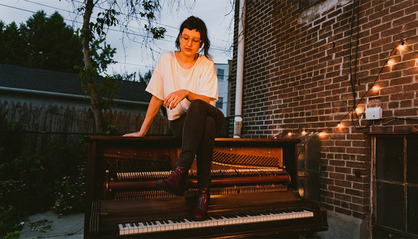 Sofia Vastek Sitting On Piano