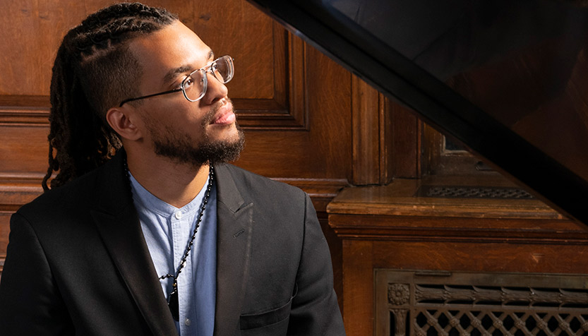 Joshua Jenkins sits at the piano