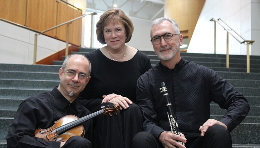 Strata Trio With Their Instruments On A Staircase