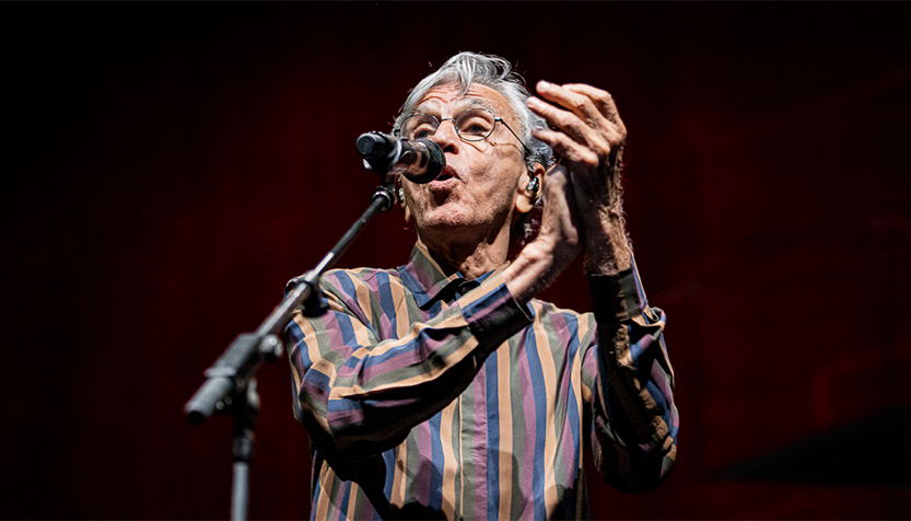 Caetano Veloso Performing At The Mic And Clapping