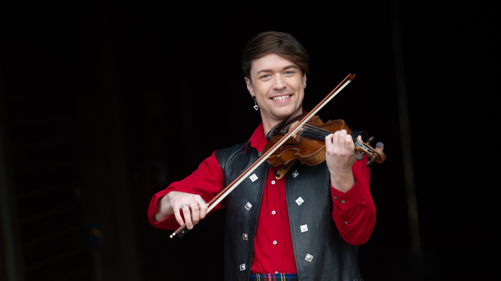 Sean Heely In Red Shirt And Leather Vest With Fiddle On Black Background