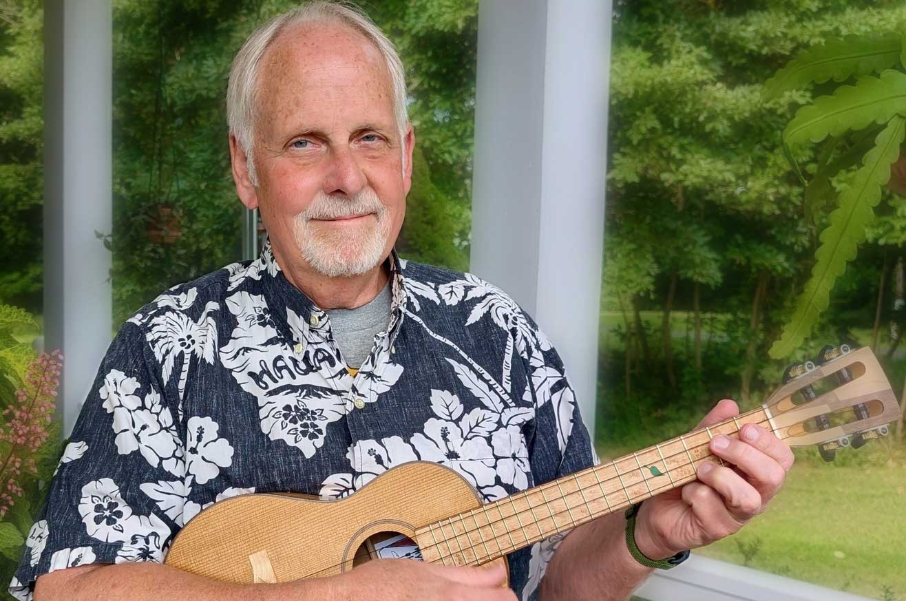 Ben Hassenger In A Hawaiian Shirt Holding His Ukulele