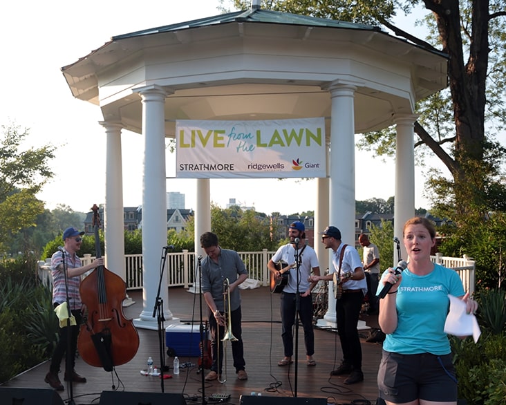 Intern At Outdoor Concert by Jim Saah