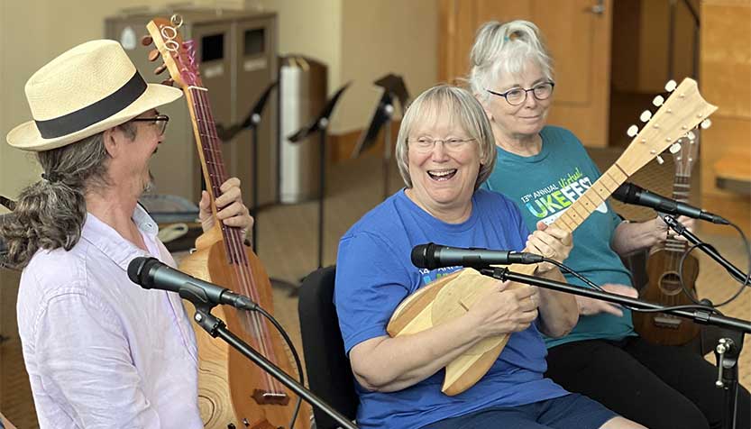 UkeFest faculty laughing with their instruments