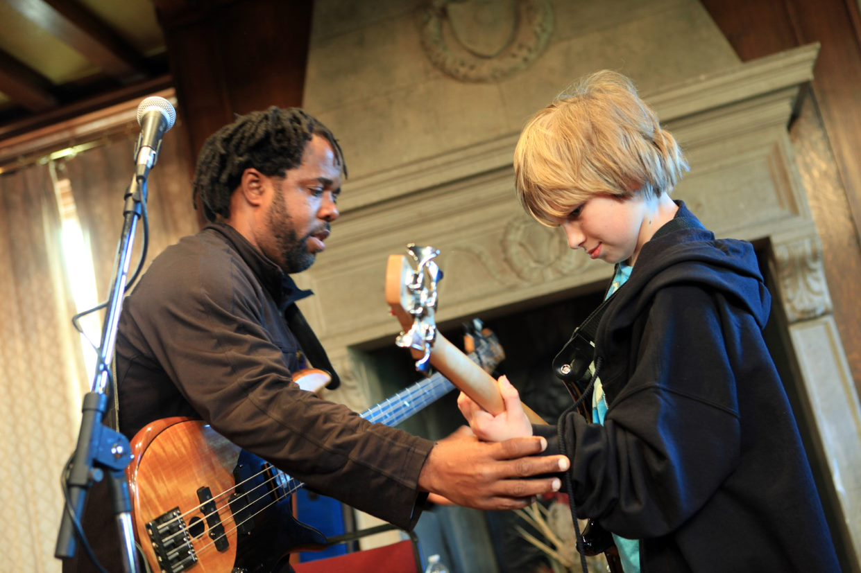 Kid Getting A Guitar Lesson