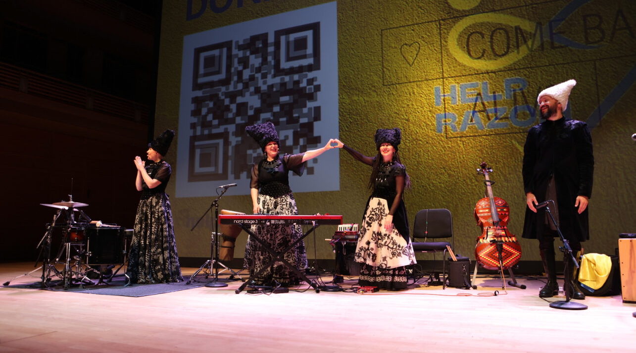 Dakha Brakha On Stage With Two Members Making A Heart With Their Combined Hands