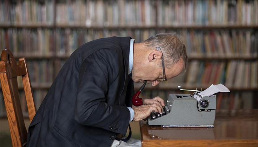 David Sedaris Leaning Over Typewriter