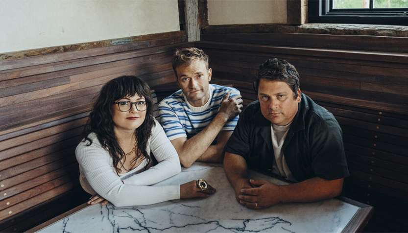 Nickel Creek Members Sitting At A Marble Table