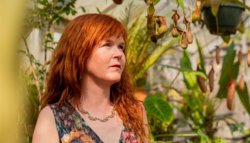 Sarah Cahill Looking Into The Distance In A Garden