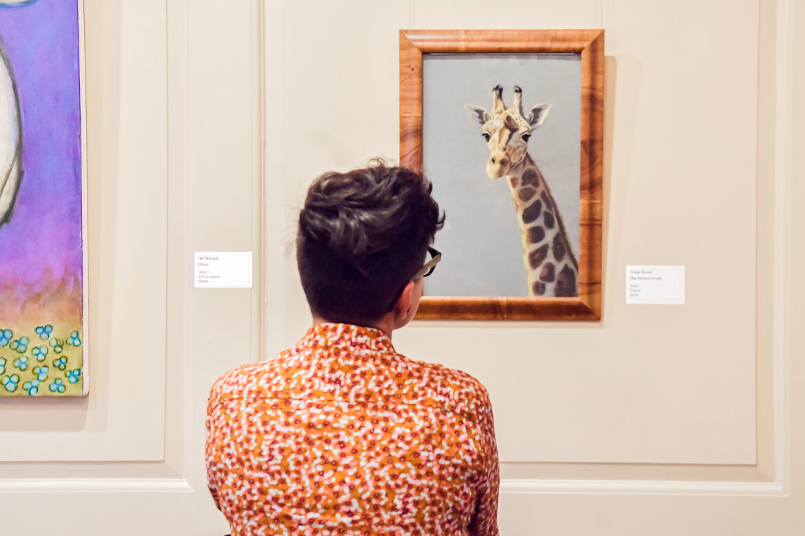 Man Looking At A Giraffe Painting In The Mansion Galleries
