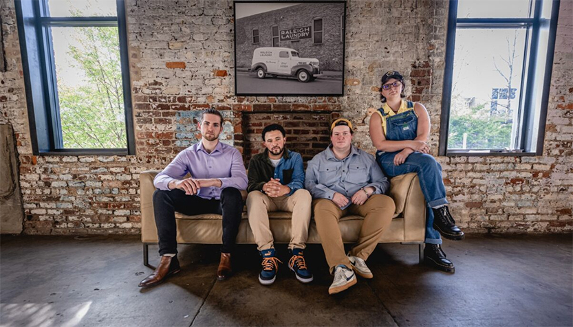 Tray Wellington Quartet Sitting On A Coach In Front Of A Brick Wall Interior