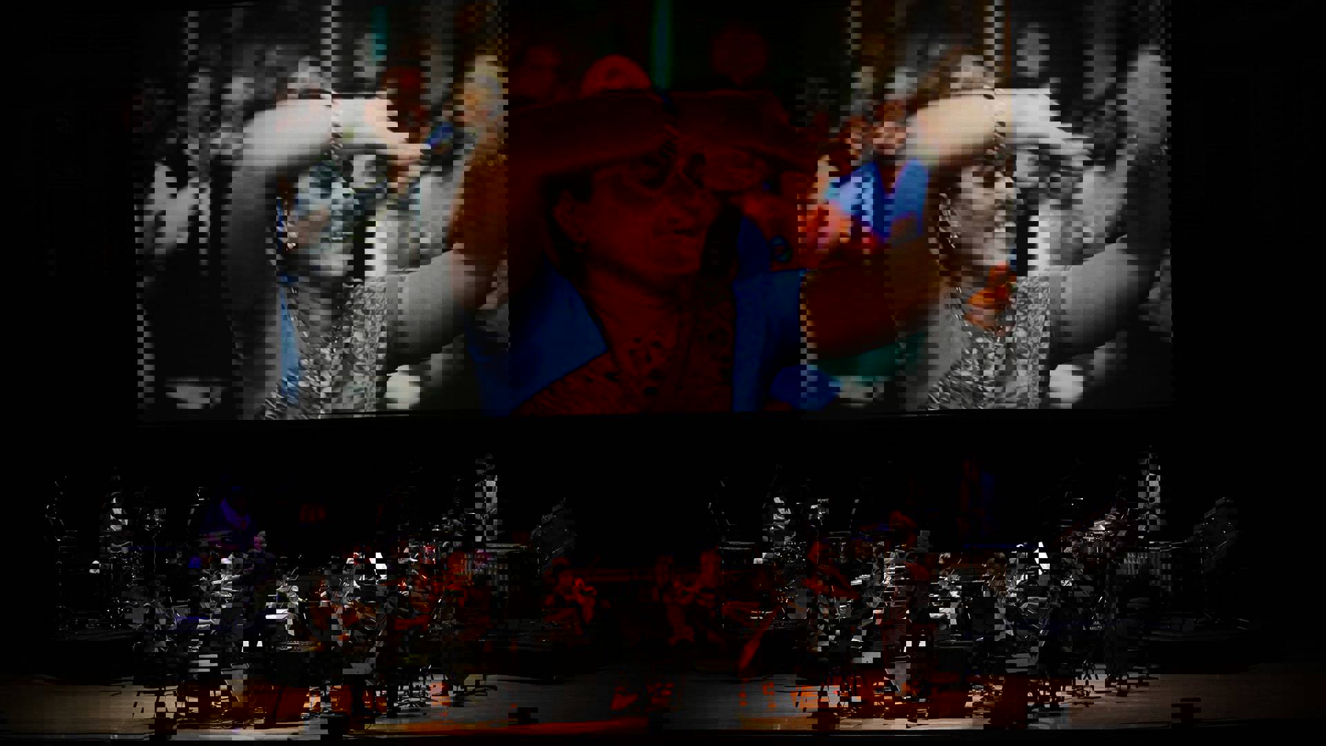 Muscians On Stage With Movie Screen Above Them In Radhe Radhe At Strathmore 1920X1080