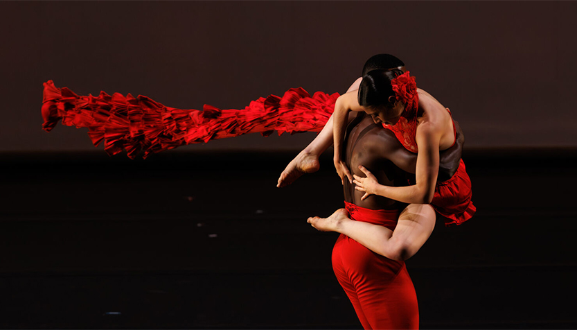 Ballet Hispanico Dancers In Red Costumes Performing A Lift