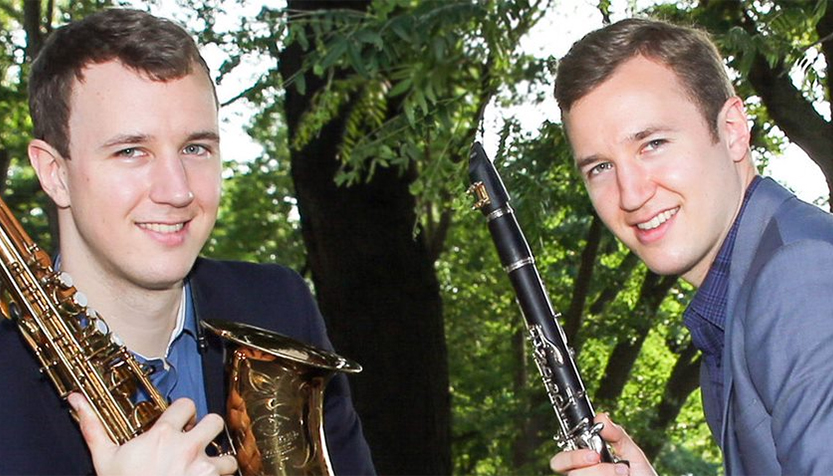 Anderson Brothers With Instruments In Front Of Trees
