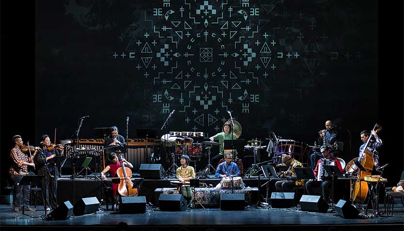 Silkroad Ensemble American Railroad Ensemble On Stage With Intricate Pattern On Screen