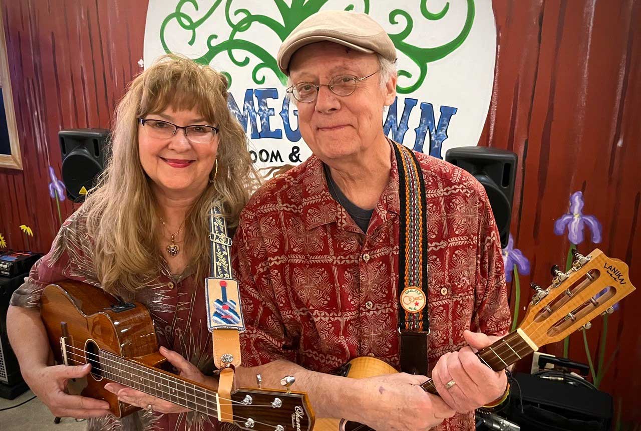 Lisa Webb And Bob Tigert Holding Their Ukuleles