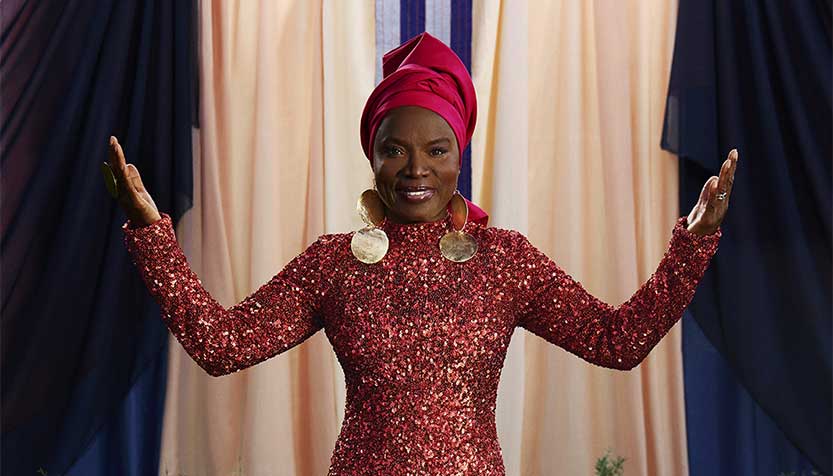 Angelique Kidjo Wearing A Turban And Red Sequined Dress